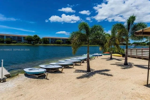 a room with pool table and chairs