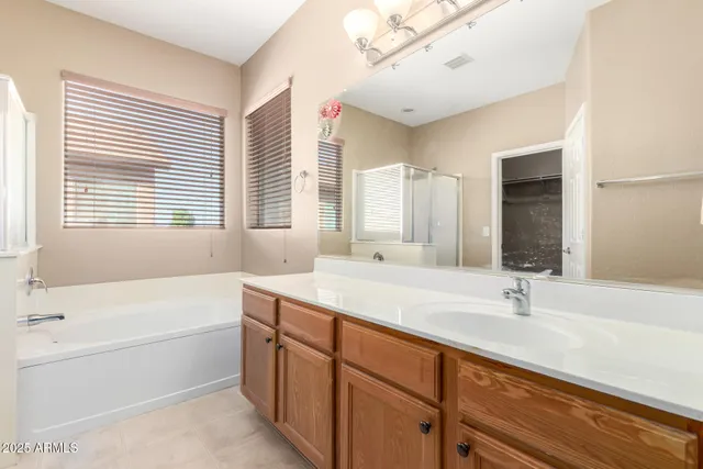 a bathroom with a tub sink and mirror