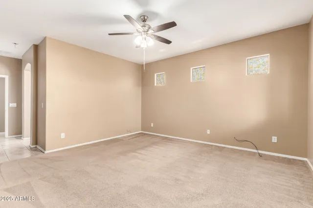 a view of an empty room with a ceiling fan