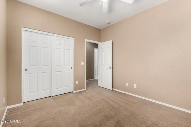 an empty room with a ceiling fan