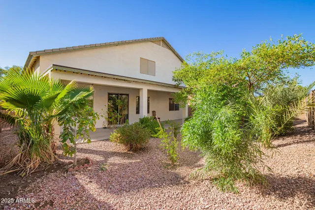 a view of a house with a yard and plants