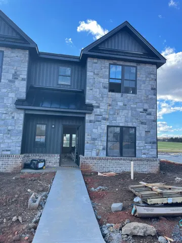 a brick house with yard in front of it