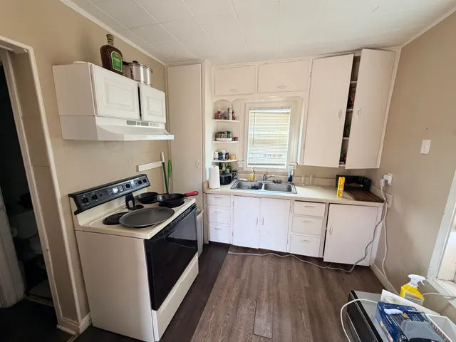 a kitchen with a sink stove and refrigerator