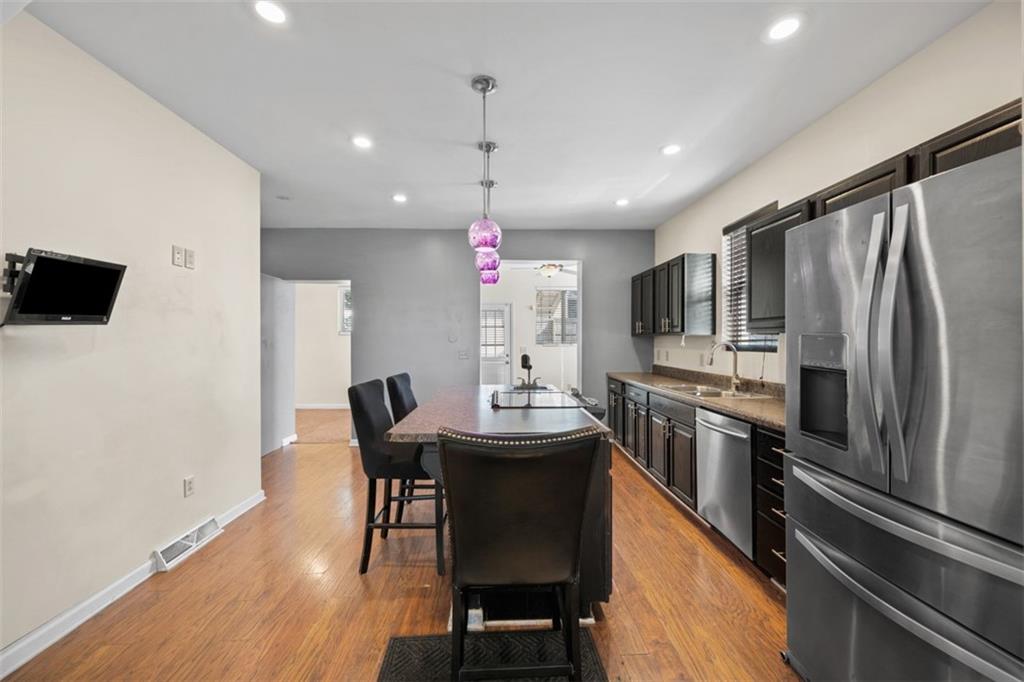 254 Ridge Avenue New Kensington, PA 15068 - Photo 11 of 50 a kitchen with kitchen island a dining table chairs stainless steel appliances and cabinets