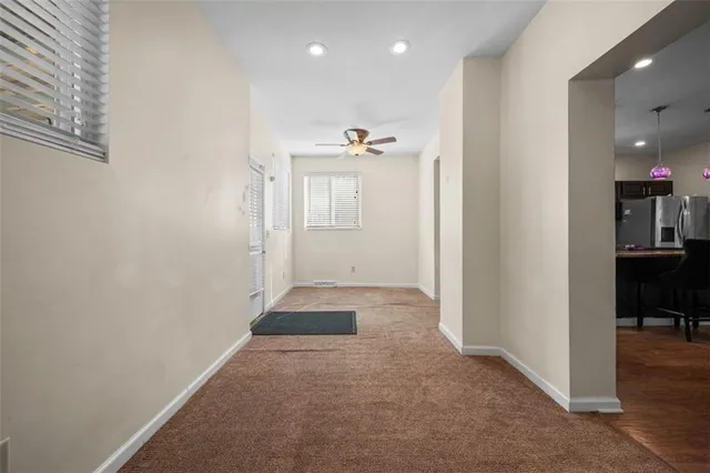 en view of a hallway with closet and a window