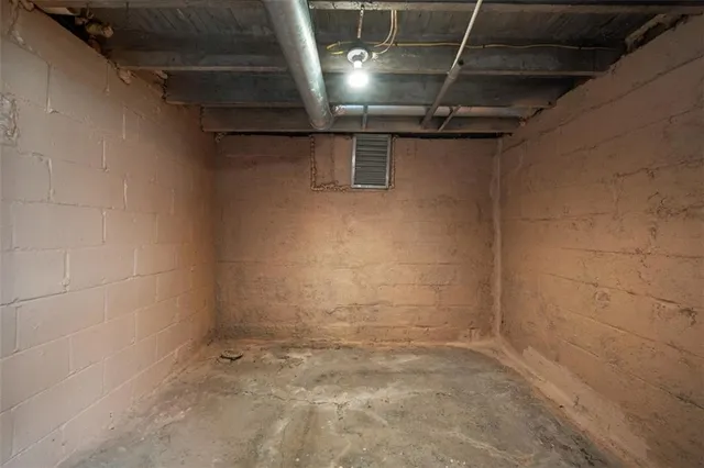 a view of a house with a garden and sitting area