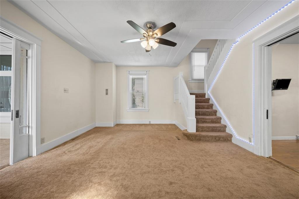 254 Ridge Avenue New Kensington, PA 15068 - Photo 7 of 50 wooden floor in an empty room with a ceiling fan and window