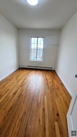 a view of a room with wooden floor and window