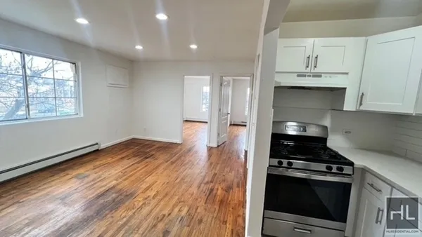 a kitchen with wooden floors and appliances