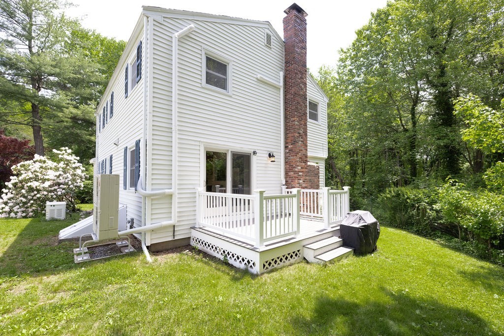21 Vanderbelt Road Acton, MA 01720 - Photo 33 of 36 a view of a white house with a yard and sitting area