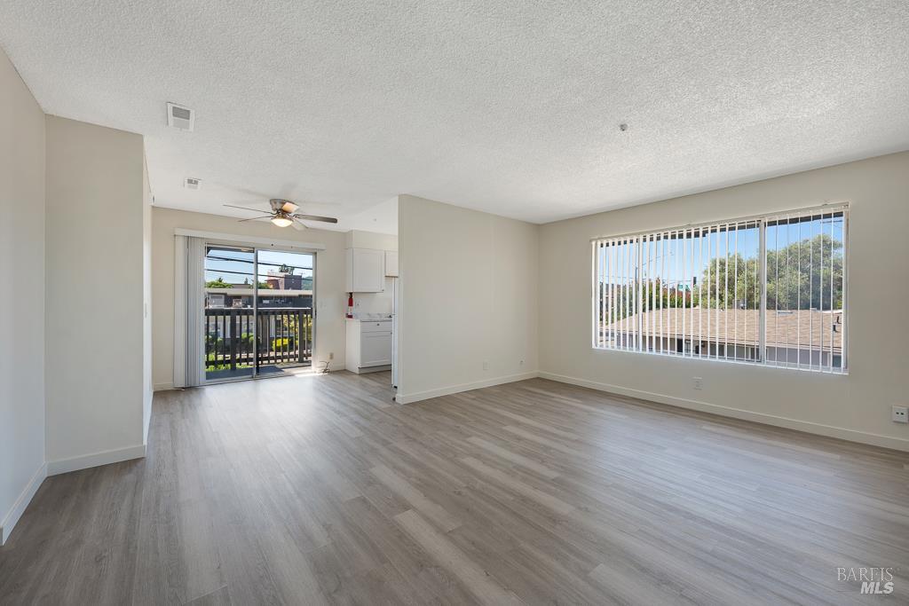 1155-1175 Evans Drive Santa Rosa, CA 95405 - Photo 22 of 31 an empty room with wooden floor and windows
