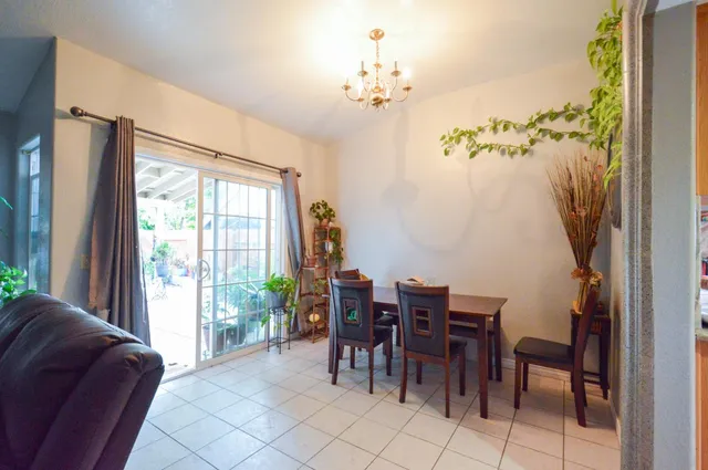a view of a dining room with furniture and chandelier