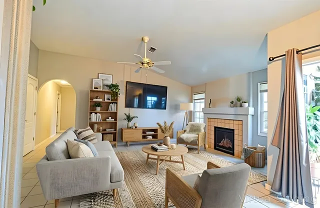 a living room with furniture a flat screen tv and a fireplace