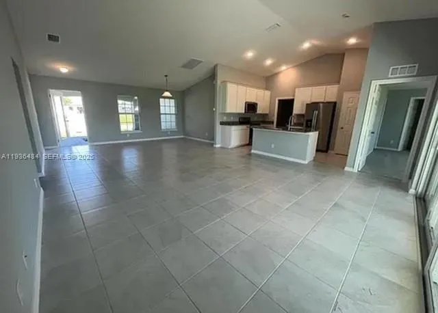 a view of a kitchen with a sink and a refrigerator