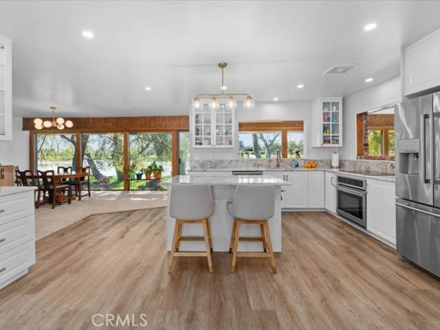 195 Howell Avenue Red Bluff, CA 96080 - Photo 20 of 67 a kitchen with stainless steel appliances a dining table chairs stove and cabinets