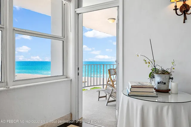 a view of a dining room with furniture and a large window