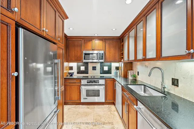 a bedroom with a bed couch and a large window
