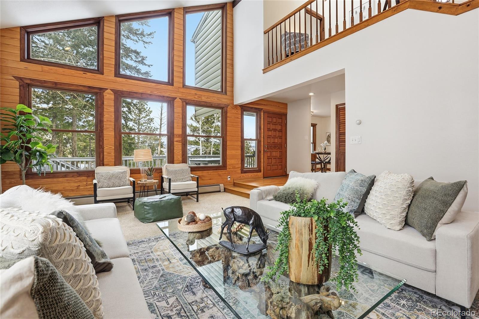 2080 Santa Fe Mountain Road Evergreen, CO 80439 - Photo 1 of 49 a living room with furniture and floor to ceiling windows
