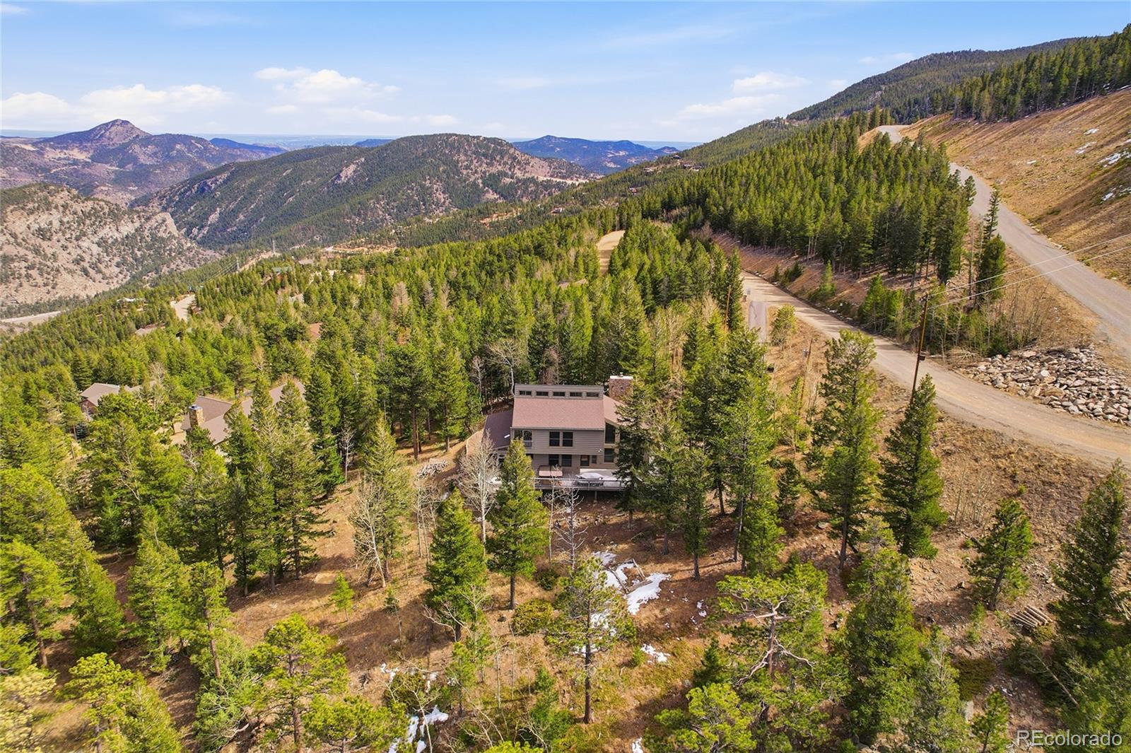 2080 Santa Fe Mountain Road Evergreen, CO 80439 - Photo 2 of 49 a view of a lush green hillside and a mountain