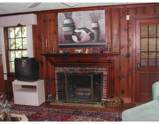 5 Marvin Road Wellesley, MA 02482 - Photo 6 of 6 a living room with a fireplace and a painting on the wall