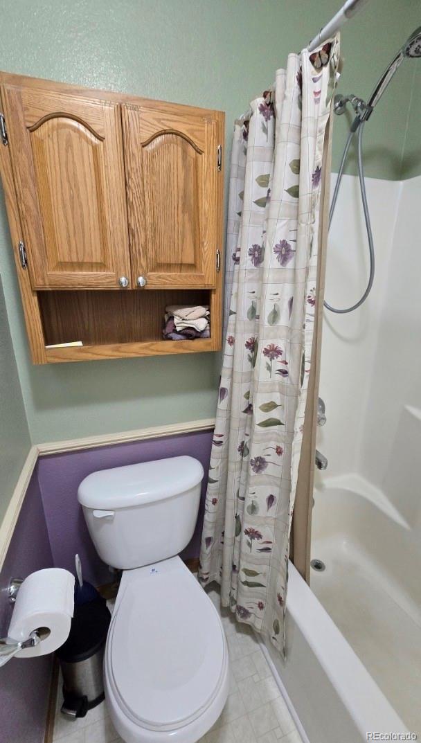 1426 3rd Street Fort Lupton, CO 80621 - Photo 15 of 50 a bathroom with a toilet and a shower
