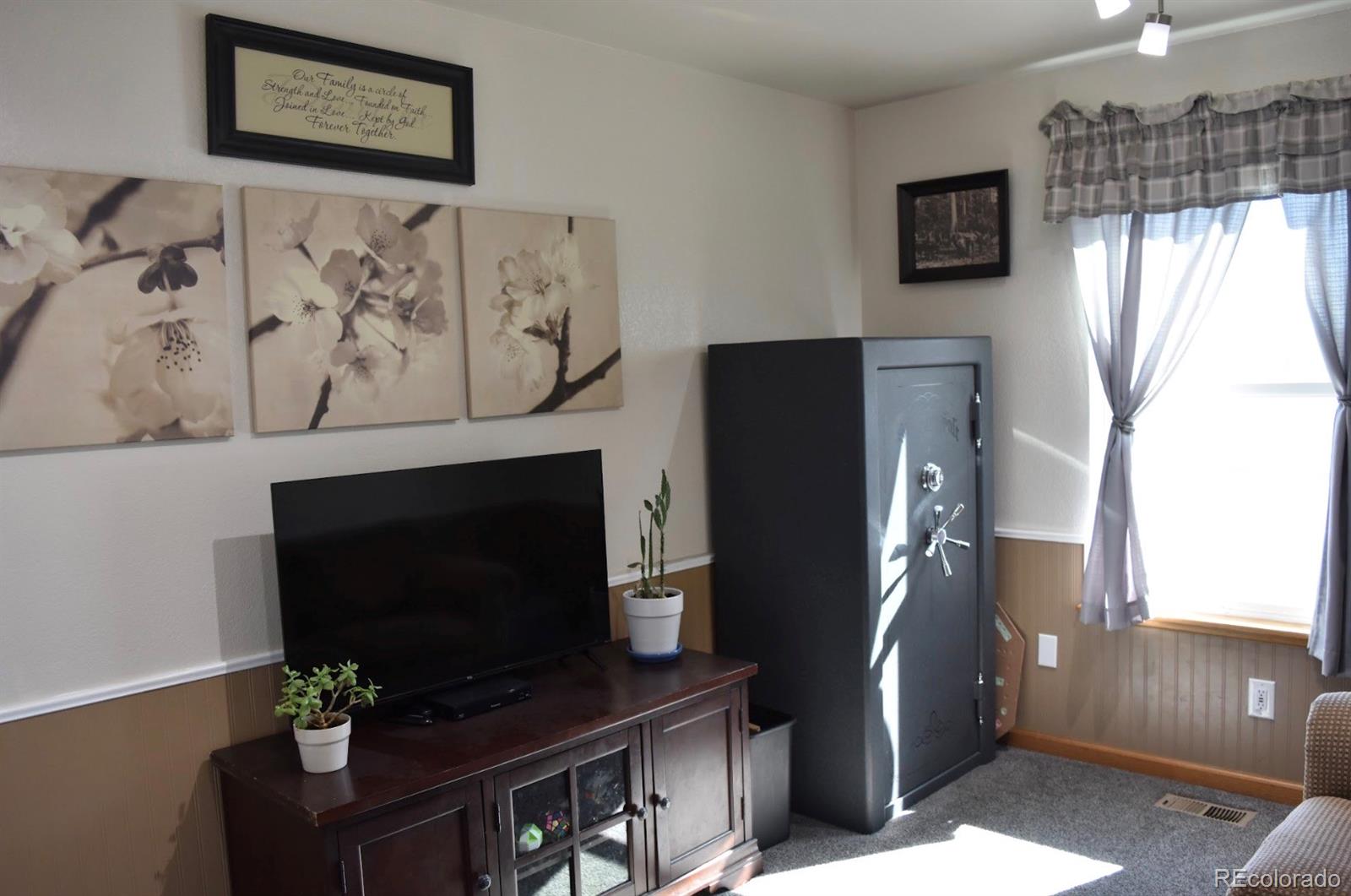 1426 3rd Street Fort Lupton, CO 80621 - Photo 17 of 50 a view of a livingroom with furniture and a flat screen tv