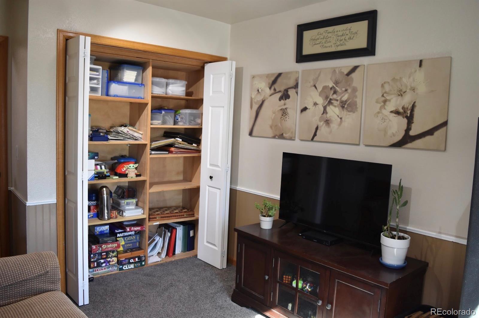 1426 3rd Street Fort Lupton, CO 80621 - Photo 19 of 50 a living room with a fireplace furniture and a flat screen tv