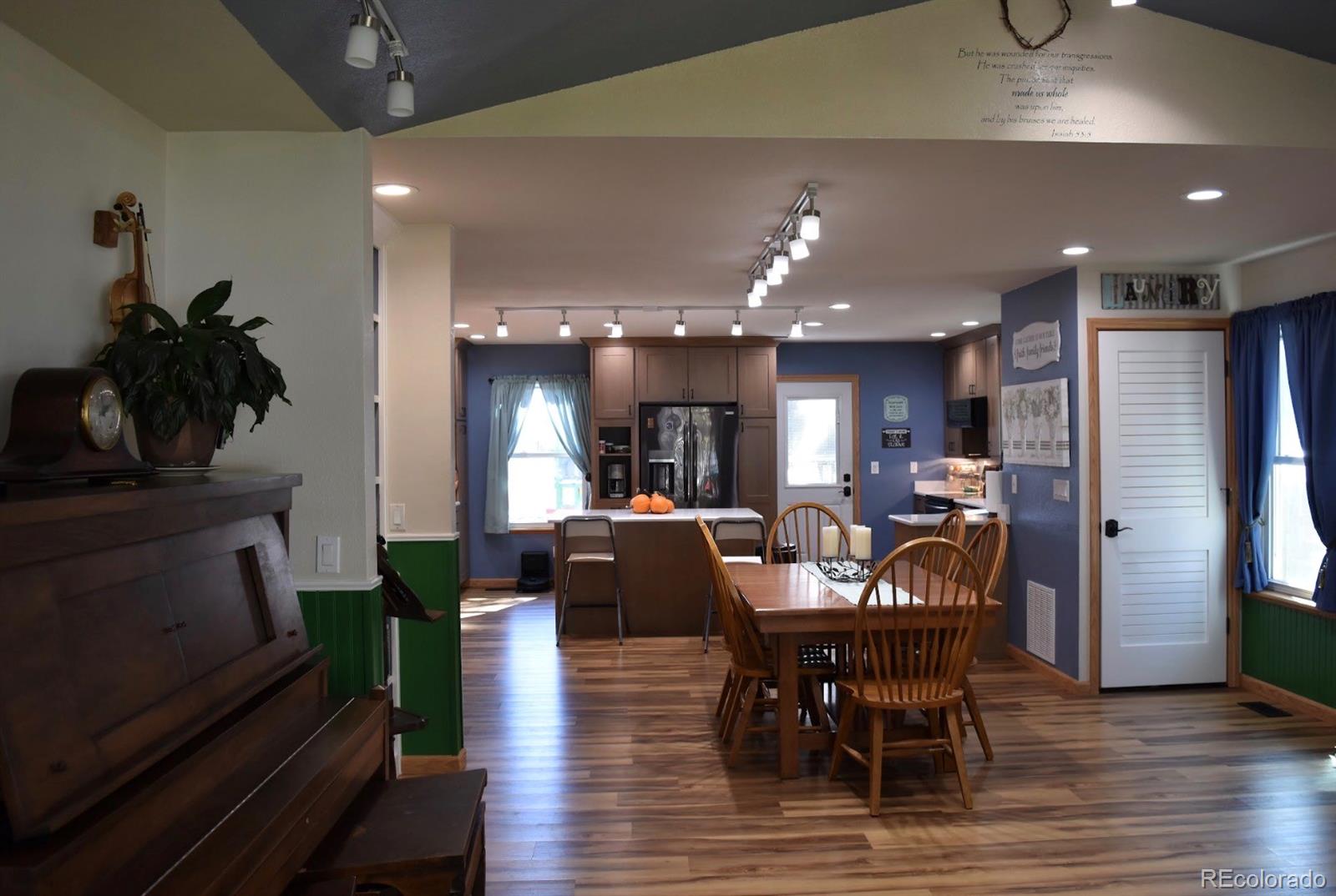 1426 3rd Street Fort Lupton, CO 80621 - Photo 2 of 50 a view of a dining room with furniture and wooden floor