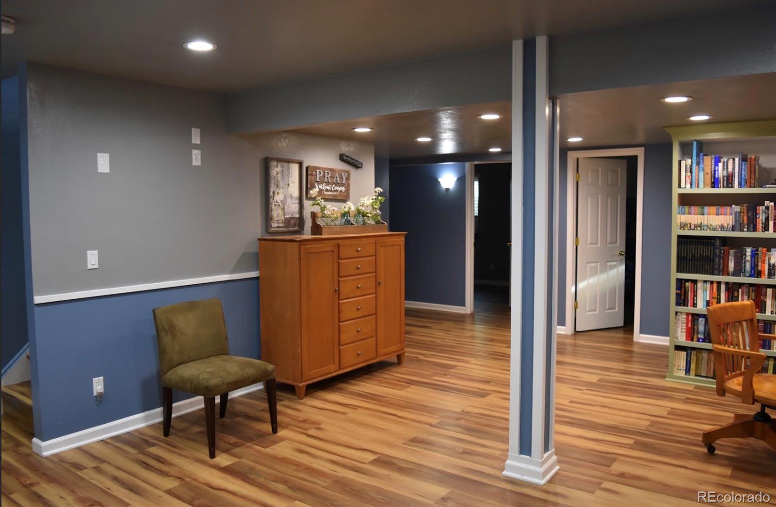 1426 3rd Street Fort Lupton, CO 80621 - Photo 22 of 50 a living room with furniture and a wooden floor
