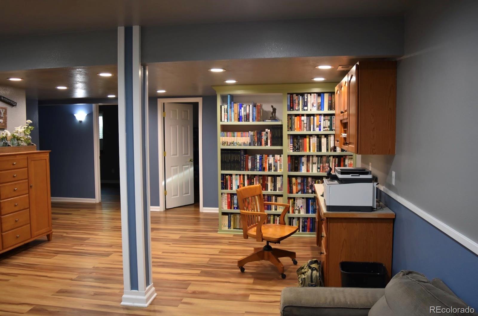 1426 3rd Street Fort Lupton, CO 80621 - Photo 23 of 50 a view of a livingroom with furniture and wooden floor