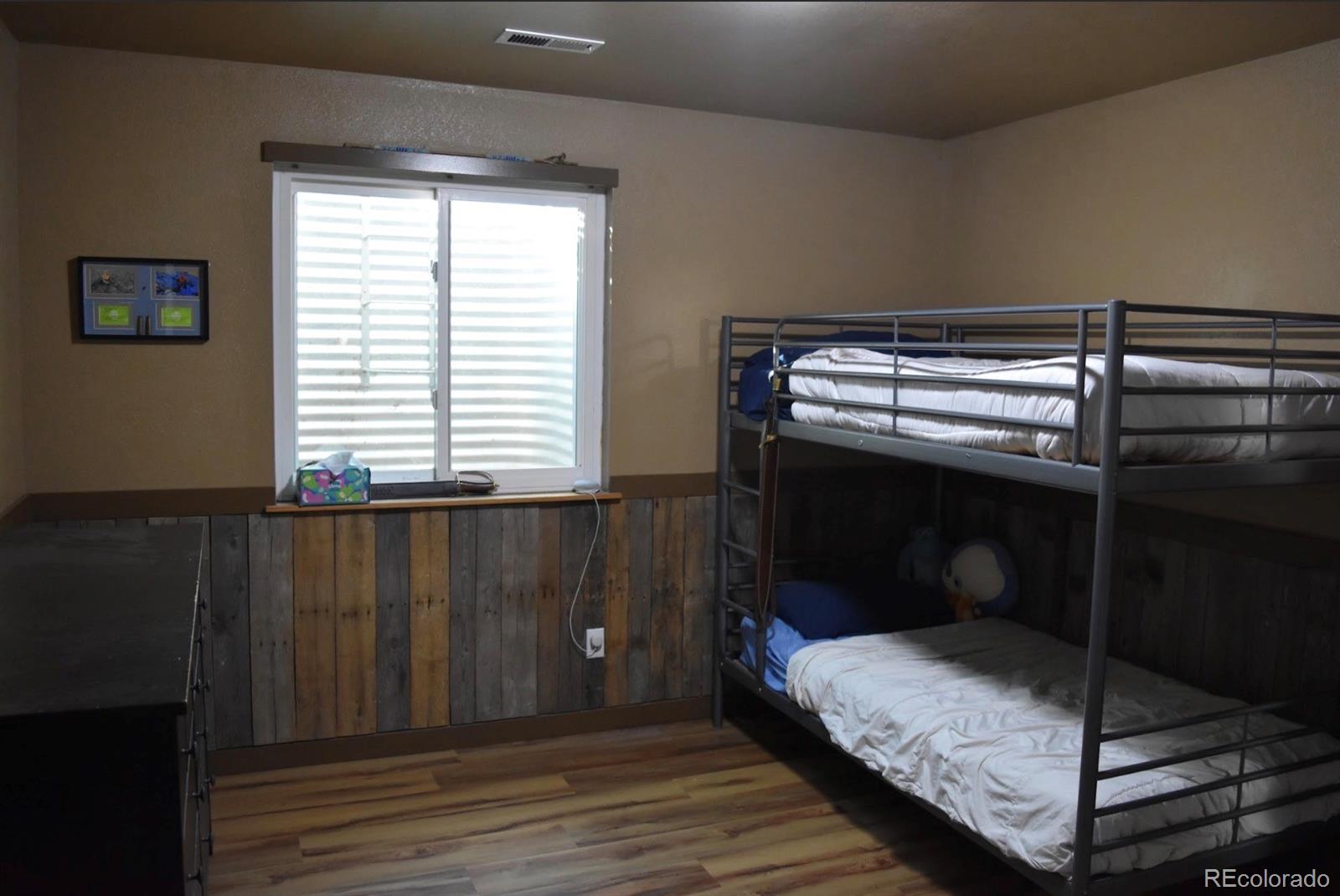 1426 3rd Street Fort Lupton, CO 80621 - Photo 31 of 50 a bedroom with a bed and a window