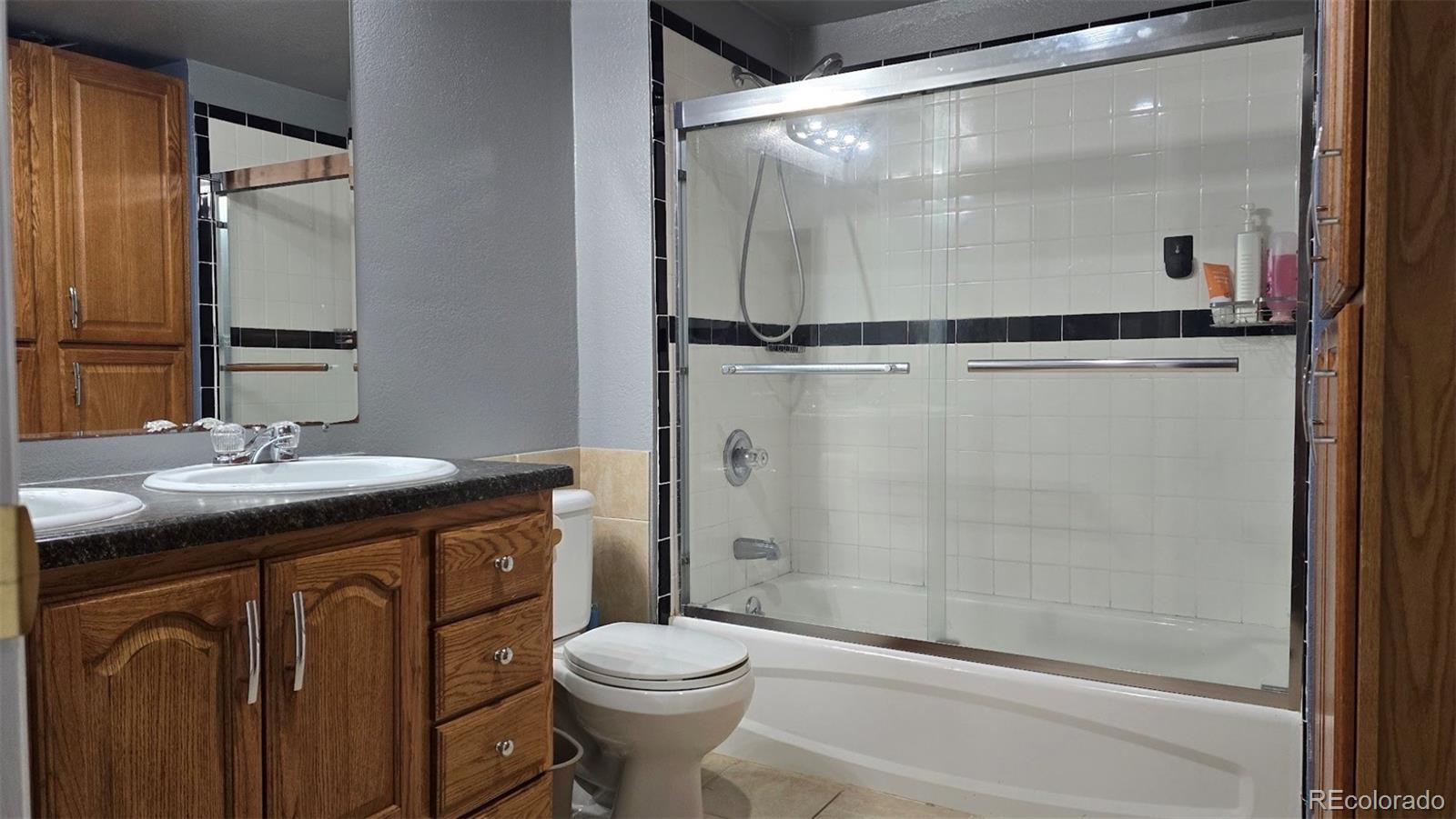 1426 3rd Street Fort Lupton, CO 80621 - Photo 33 of 50 a bathroom with a sink a toilet and shower