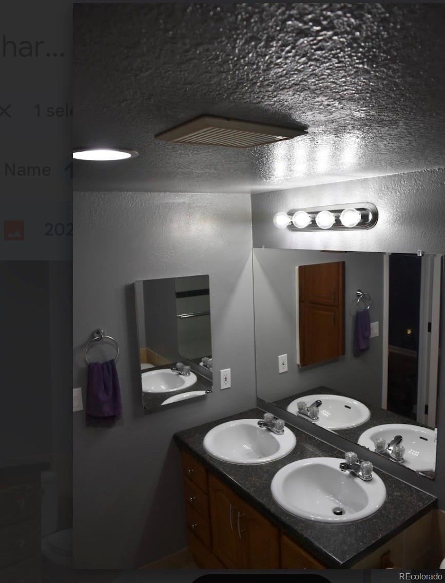 1426 3rd Street Fort Lupton, CO 80621 - Photo 34 of 50 a bathroom with a sink and a mirror