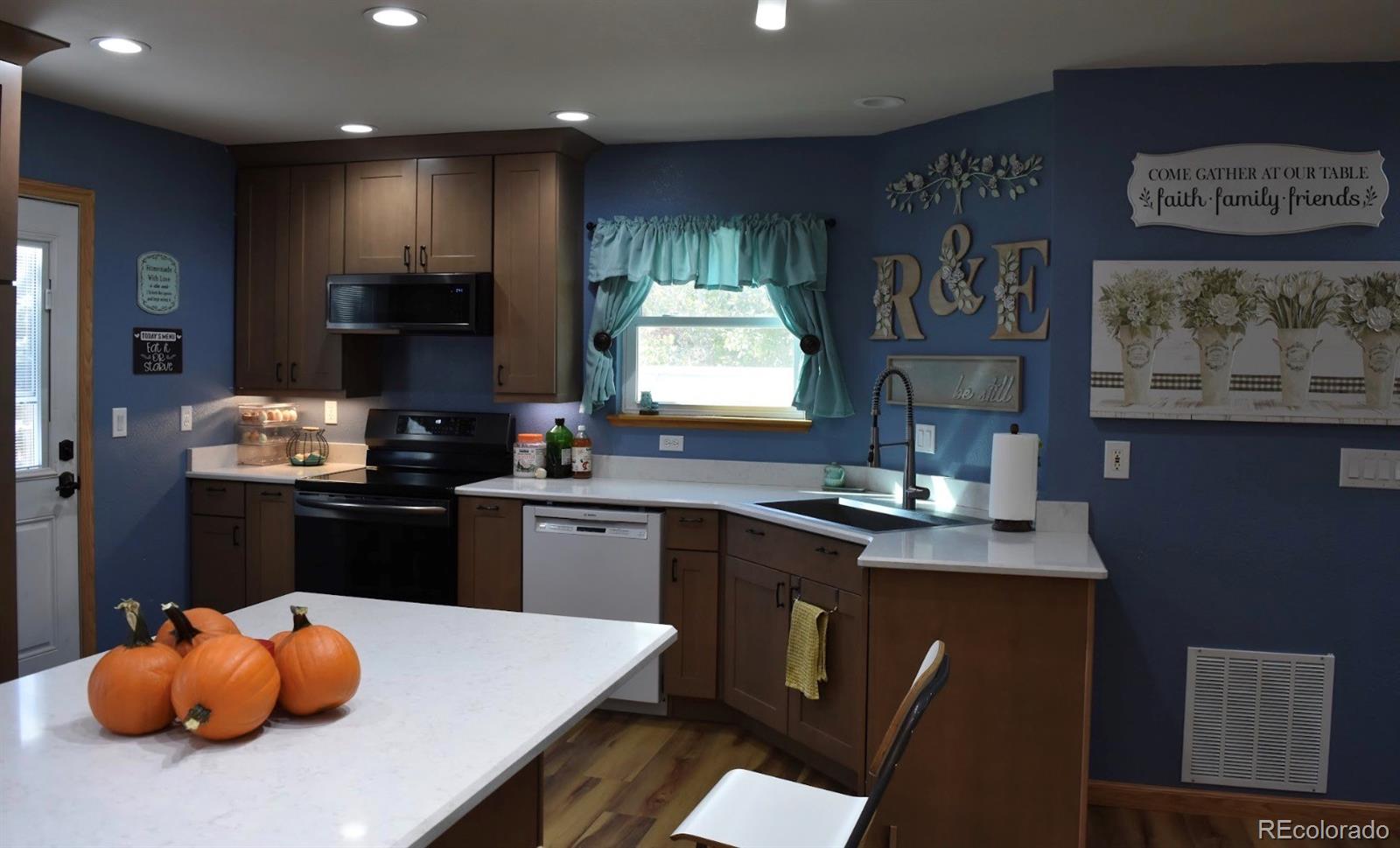 1426 3rd Street Fort Lupton, CO 80621 - Photo 4 of 50 a kitchen with stainless steel appliances granite countertop a sink dishwasher a stove and a refrigerator