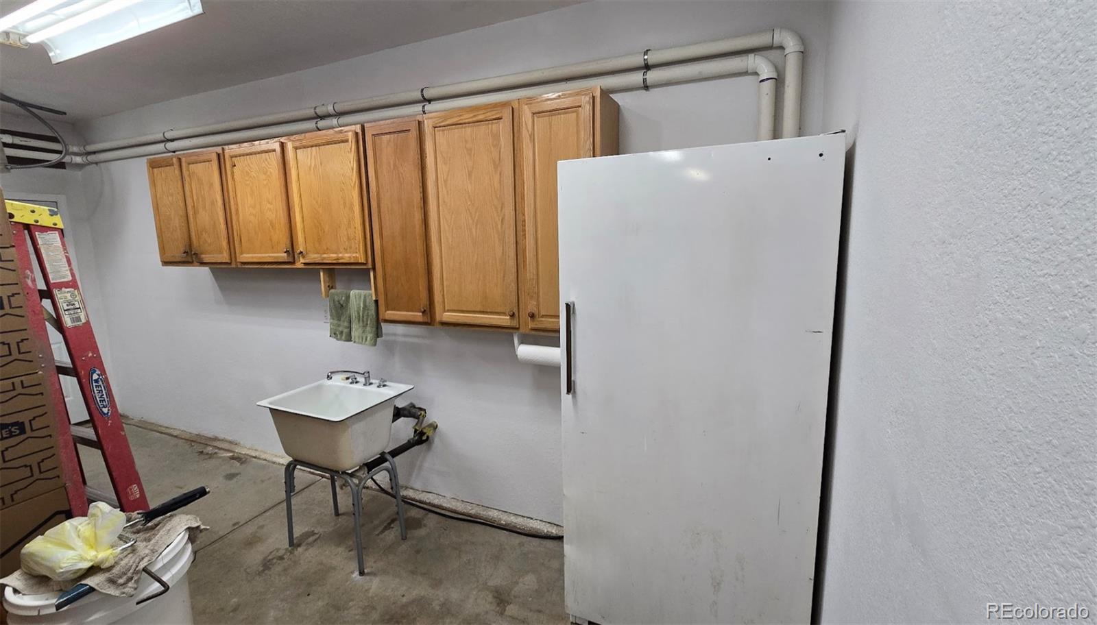 1426 3rd Street Fort Lupton, CO 80621 - Photo 48 of 50 a view of kitchen with furniture and a refrigerator
