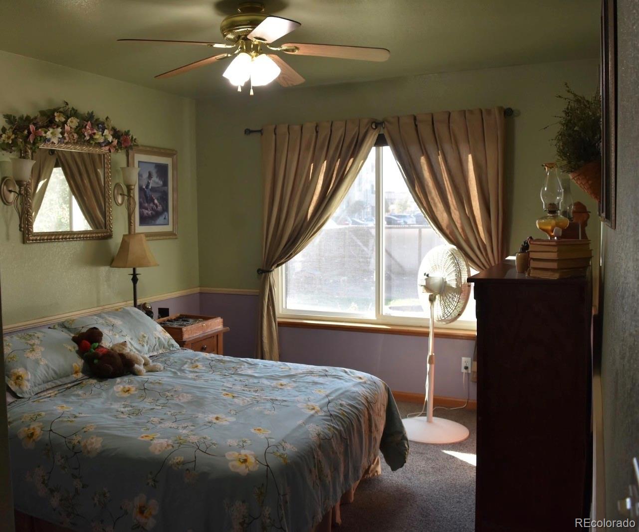 1426 3rd Street Fort Lupton, CO 80621 - Photo 10 of 50 a bedroom with a bed and window