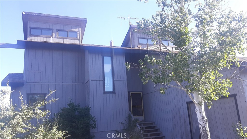 23441 El Rancho Drive Tehachapi, CA 93561 - Photo 2 of 30 a view of a wooden door and a tree