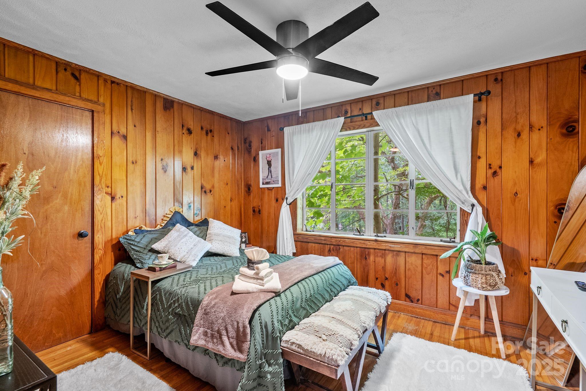 41 Hilton Drive Brevard, NC 28712 - Photo 27 of 32 a bedroom with a bed and a chandelier