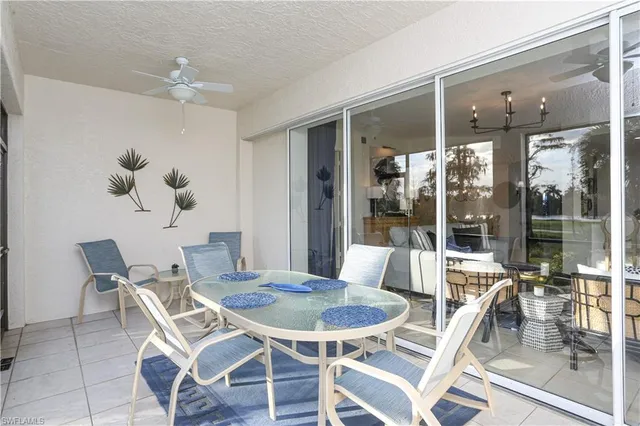 a dining room with furniture a chandelier and window