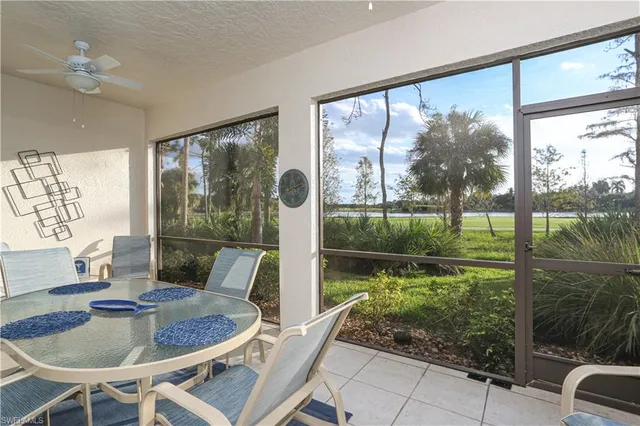 a dining room with garden view and a floor to ceiling window