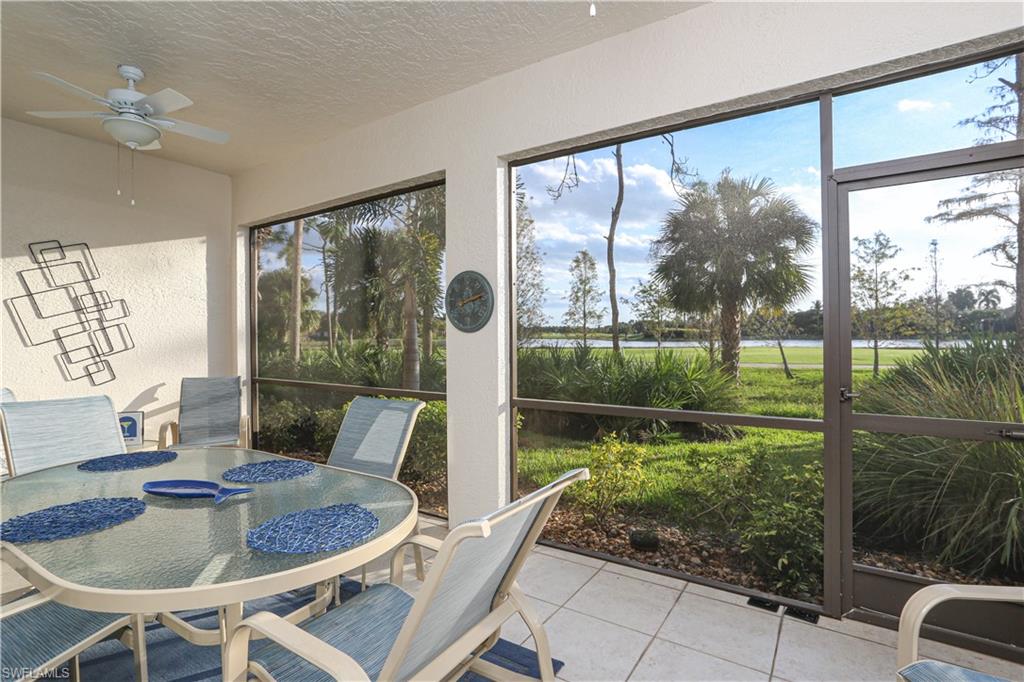 3930 Deer Crossing Court, Unit 3103 Naples, FL 34114 - Photo 15 of 50 a dining room with garden view and a floor to ceiling window