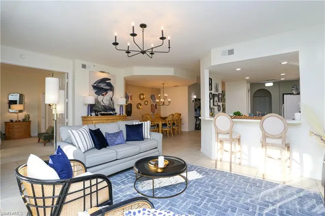 a living room with furniture and a view of kitchen