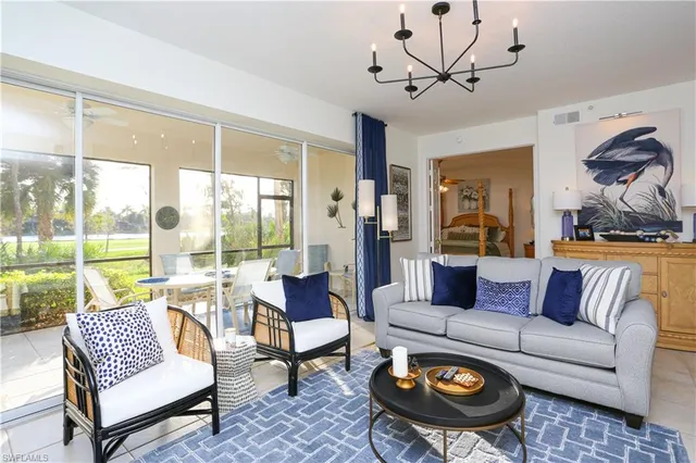 a living room with furniture and a large window with garden view