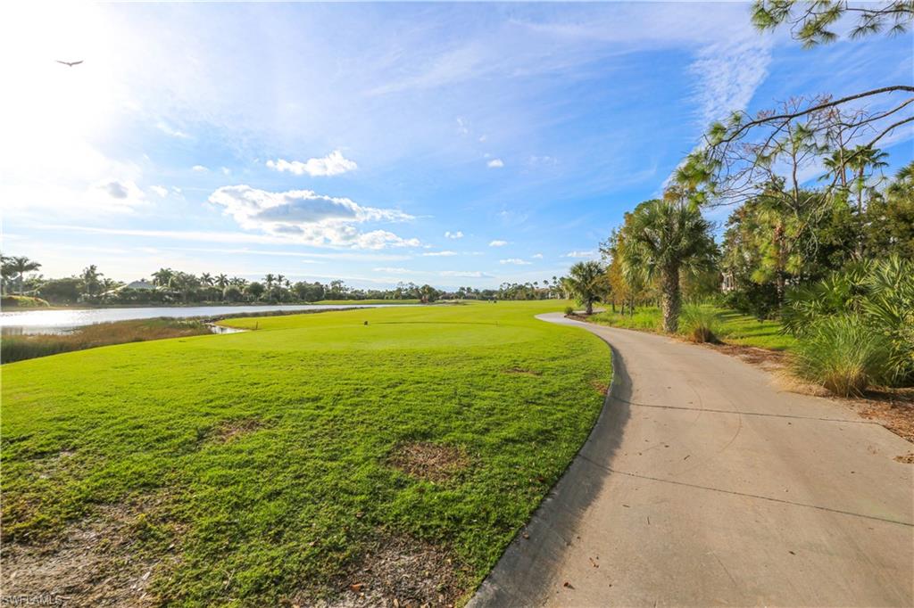 3930 Deer Crossing Court, Unit 3103 Naples, FL 34114 - Photo 2 of 50 a view of a lake and a yard