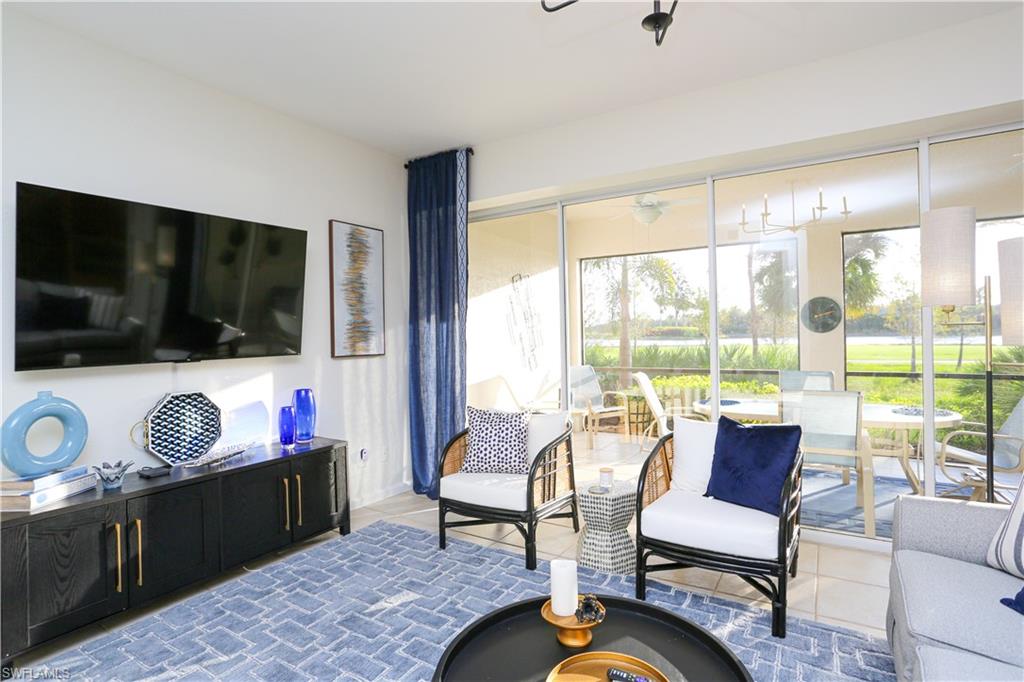 3930 Deer Crossing Court, Unit 3103 Naples, FL 34114 - Photo 21 of 50 a living room with furniture and a flat screen tv