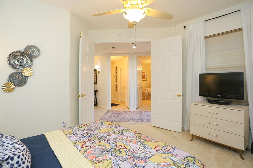 3930 Deer Crossing Court, Unit 3103 Naples, FL 34114 - Photo 24 of 50 a bedroom with a bed and flat screen tv