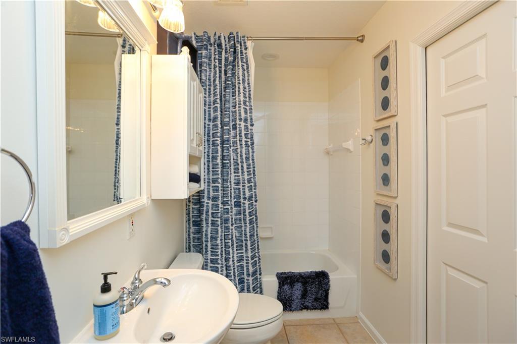 3930 Deer Crossing Court, Unit 3103 Naples, FL 34114 - Photo 27 of 50 a bathroom with a sink toilet and shower