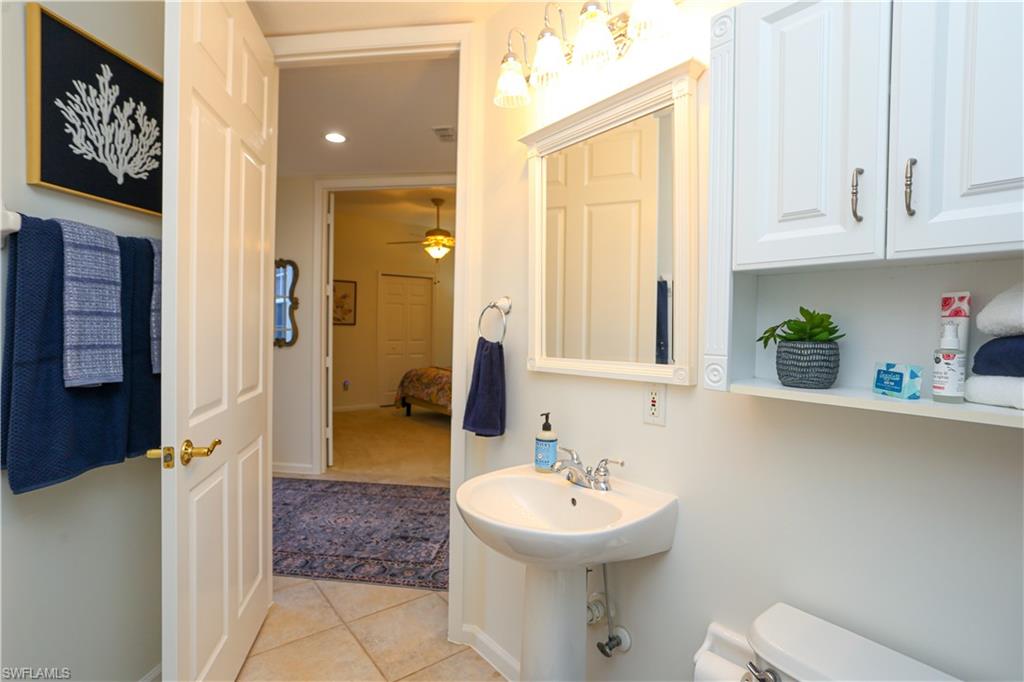 3930 Deer Crossing Court, Unit 3103 Naples, FL 34114 - Photo 28 of 50 a bathroom with a sink a toilet and shower