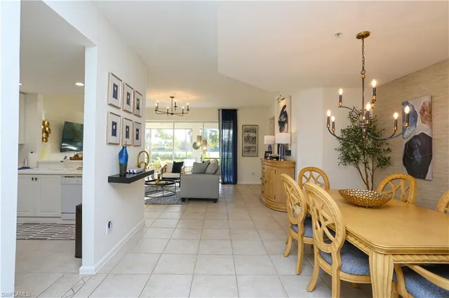 a kitchen with furniture and a potted plant