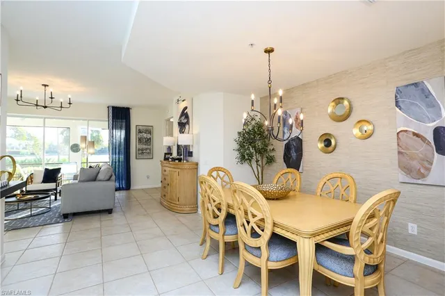 a dining room with furniture and a chandelier